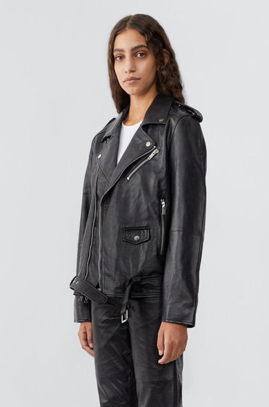 Model wearing Deadwood biker jacket in black, a classic rider style jacket that features all the right details including a practical inside pocket. Made from upcycled leather.   