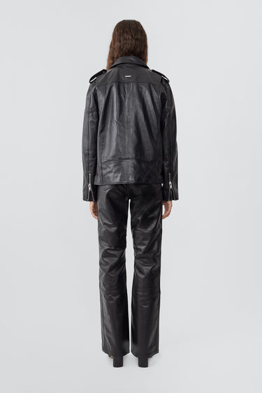 Model wearing Deadwood biker jacket in black, a classic rider style jacket that features all the right details including a practical inside pocket. Made from upcycled leather.   