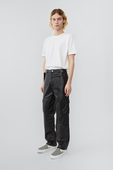 Model wearing straight cut cargo Deadwood pants with slightly dropped crotch, zip fly and workwear-inspired double waist pockets and leg pockets. One 32” length fits all.