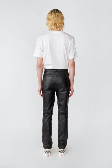 Man wearing black Phoenix slim-fit leather pants by Deadwood, made from recycled leather and PET bottles.