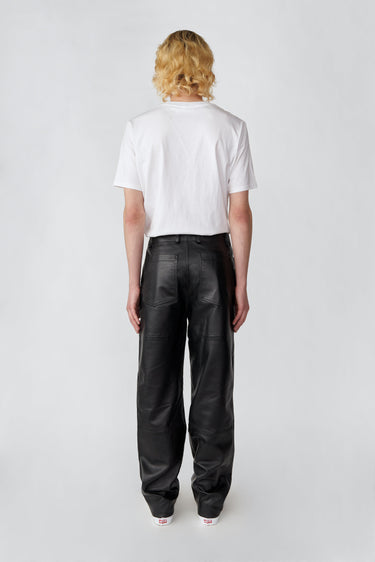 Model from the back in black Presley recycled leather pants by Deadwood, high-waisted wide-leg design with workwear details.