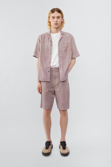 Model wearing Deadwood short sleeve suede shirt in the color lavender, inspired by vintage hawaiian shirts. Made from recycled suede.