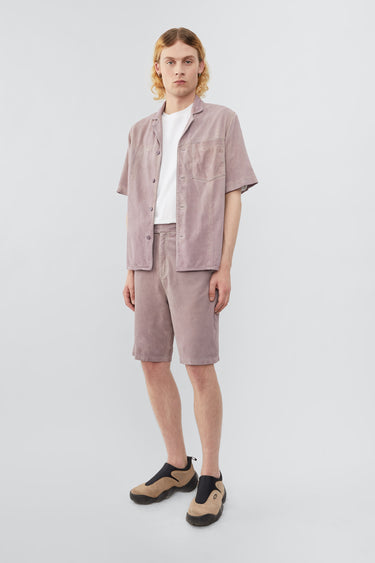 Model wearing Deadwood short sleeve suede shirt in the color lavender, inspired by vintage hawaiian shirts. Made from recycled suede.