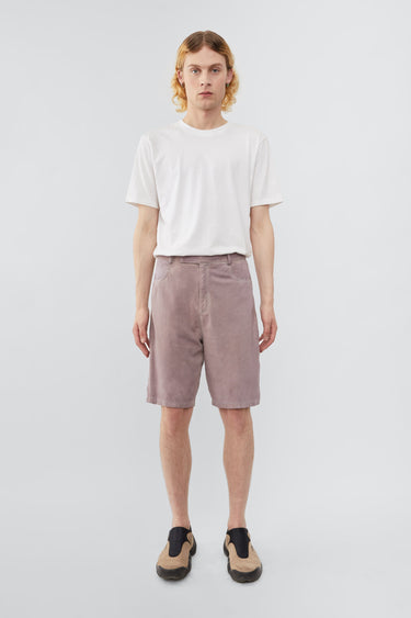 Model wearing Deadwood knee-length suede board shorts in the color lavender. Hook and zipper closure and right back pocket. Made from recycled suede.