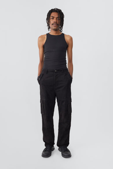 Model wearing black Deadwood straight cut cargo pants with slightly dropped crotch, zip fly and workwear-inspired double waist pockets and leg pockets. One 32” length fits all.  Made from recycled suede. 