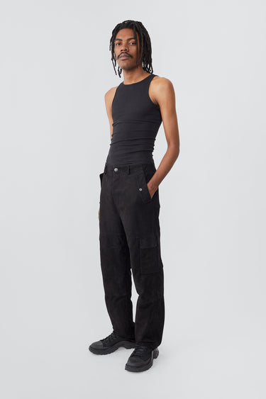 Model wearing black Deadwood straight cut cargo pants with slightly dropped crotch, zip fly and workwear-inspired double waist pockets and leg pockets. One 32” length fits all.  Made from recycled suede. 