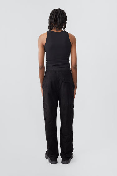 Model wearing black Deadwood straight cut cargo pants with slightly dropped crotch, zip fly and workwear-inspired double waist pockets and leg pockets. One 32” length fits all.  Made from recycled suede. 