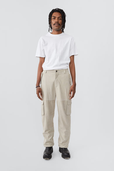 Model in Convoy off-white suede pants by Deadwood, cargo-style with tapered fit and eco-conscious materials.
