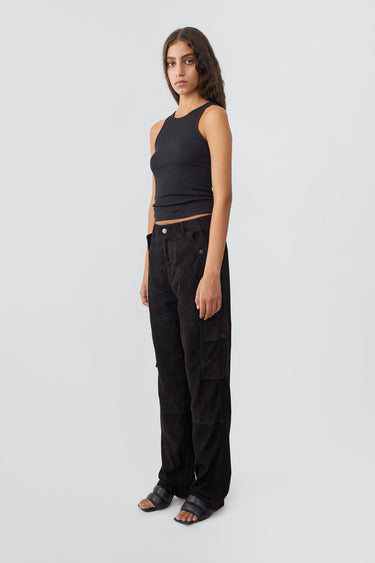 Side profile of model in black Convoy Suede Pants by Deadwood, workwear-inspired cargo pants in upcycled goat suede with a tapered fit and eco-conscious materials.
