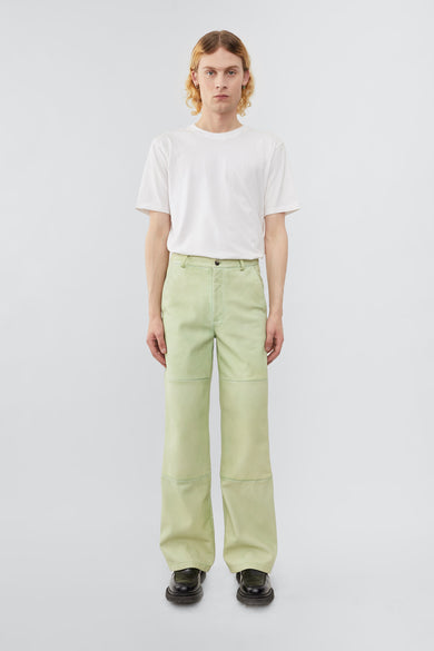 Model wearing Deadwood leather pants with a casual straight to semi wide fit. Here in color lime. Made from recycled leather.