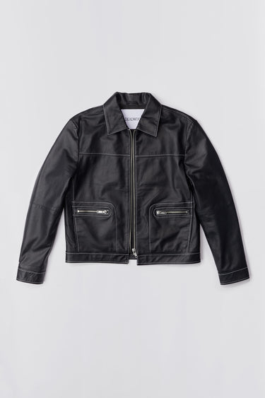 Straight-cut leather Deadwood jacket that echoes both 60's and 90's aesthetics. Black with white stitching all around. Made from upcycled leather.