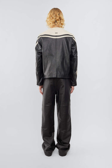 Model from the back in Deadwood Racer Jacket, two-tone black and off-white leather with moto-inspired details.