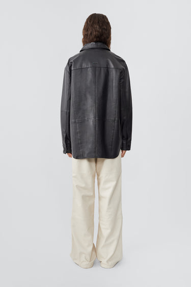 From the back model wearing Shoreline black leather over-shirt by Deadwood, made from upcycled leather and recycled plastic bottles.