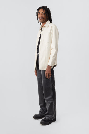 Side profile of model in off-white Spike Shirt by Deadwood, relaxed-fit leather overshirt with recycled PET lining.