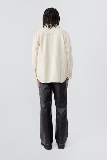 Model from the back in off-white Spike Shirt by Deadwood, relaxed-fit leather overshirt with recycled PET lining.