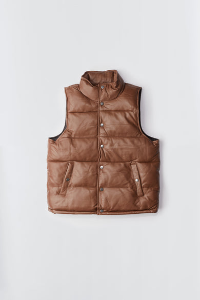 Deadwood brown down-free recycled leather puffer vest with push button closure at center front. Waist pockets and a drawstring at the hem. 